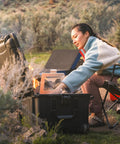 Trail 80 Waterproof Storage Box With Wheels, 79L Outdoor Gear Case For Camping, shown being used at a campsite