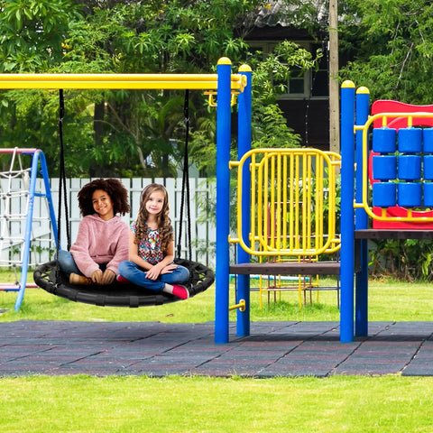 Two children sitting on a 40 Inch Flying Saucer Tree Swing For Kids Heavy Duty Outdoor Disc Round Swing in a playground.