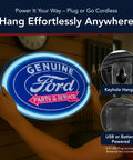 Hands holding a blue LED neon rope wall sign shaped like a classic Ford logo with buzz-free battery or USB power, suitable for bars or game rooms.