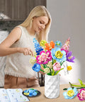 Flower Bouquet Building Kit For Adults And Kids 8 Plus, 13 Colorful Stems From 8 Varieties Like Peony, Rose, Hydrangea, Snowball, Narcissus, Snapdragon, And Consolida, A Dope DIY Home Decor Gift For Creative Crafters. woman assembling ABS brick flower bouquet in vase