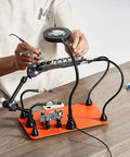 Magnetic Helping Hands Soldering Station With 3X LED Magnifying Lamp, 4 PCB Holders in use for electronics repair on table
