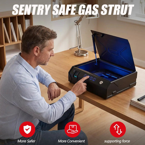 Man using a black safe with Sentry Safe branding and visible gas strut mechanism on a wooden desk