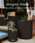 2-In-1 Outdoor Cooler Side Table in Black near pool with plants, keeps 48 cans cold for 12 hours, 40L ice capacity, patio use
