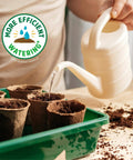 Person watering pots in a tray with 3-In-1 Seed Starting Mix For Herbs, Veggies, And Flowers, 6 Quarts, 100 Percent Organic And USA Made.