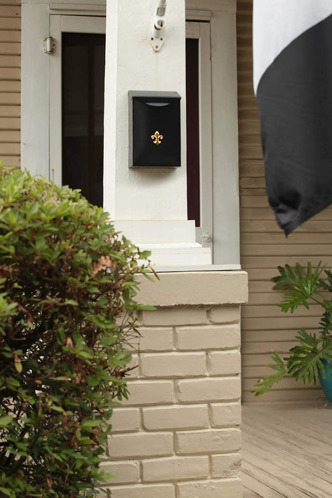 Classic Small Capacity Galvanized Steel Black Wall Mount Mailbox With Fleur De Lis Emblem on porch