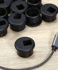 10 Pack Desk Grommets Plastic Cable Hole Covers For Wire Management Black 1 Inch Grommets on a wooden surface with cable