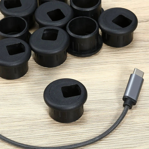 10 Pack Desk Grommets Plastic Cable Hole Covers For Wire Management Black 1 Inch Grommets on a wooden surface with cable