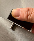Heavy Duty Self Centering Scribe Equipped With Tungsten Carbide Pin And Hardened Steel Guide Locks, held in hand for precise layout.