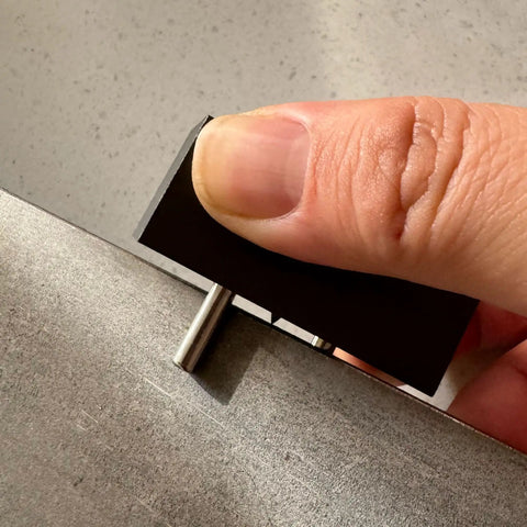 Heavy Duty Self Centering Scribe Equipped With Tungsten Carbide Pin And Hardened Steel Guide Locks, held in hand for precise layout.
