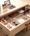 Clear Drawer Organizer Set 25 Piece Plastic Storage Bins for makeup in wood vanity drawer, showing modular stackable trays