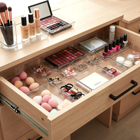 Clear Drawer Organizer Set 25 Piece Plastic Storage Bins for makeup in wood vanity drawer, showing modular stackable trays