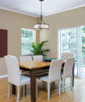 Dining room with Scarlett 17 Inch 4 Light Modern Drum Chandelier with Rippled Glass Panel Shade in Oil Rubbed Bronze Finish
