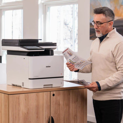 Man using Color Laser All In One Printer With Duplex Printing, Scan And Copy, Fast 33 Pages Per Minute in office