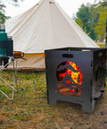 20 Inch Portable Wood Burning Fire Pit Collapsible For Camping And Backyard Use Tailgate Ready Ultra Compact Easy Assembly With Interlocking Design Great For Deck Or Patio Black shown in a campsite with a tent and trees in the background.