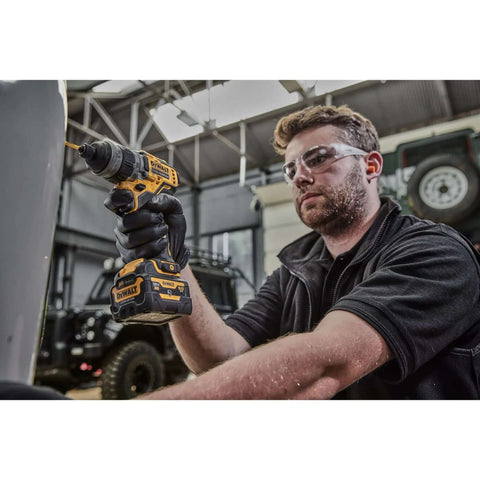 Man using Compact 12V Cordless Drill Driver Workhorse with right angle bit for tight spaces in a workshop setting.