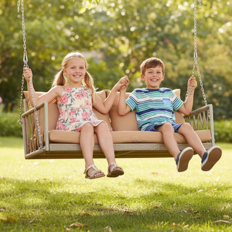 Children sitting on a Wicker Porch Swing With Cushioned Seat And Armrests Hangout Ready Outdoor Hanging Swing Bed with Steel Chains in a garden.