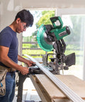 Person using 12-Inch Compound Miter Saw With Xact Cut LED Shadow Line System And Dual Bevel, 15 Amp Motor for woodworking.