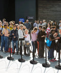 Crowd guided by Four 34 Inch Plastic Traffic Delineator Cones With Weighted Fillable Base Portable Safety Posts in a line.