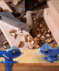 Heavy Duty Table Vise With Swivel Base For Woodworking And Metalworking, shown on a workbench with wood shavings and tools
