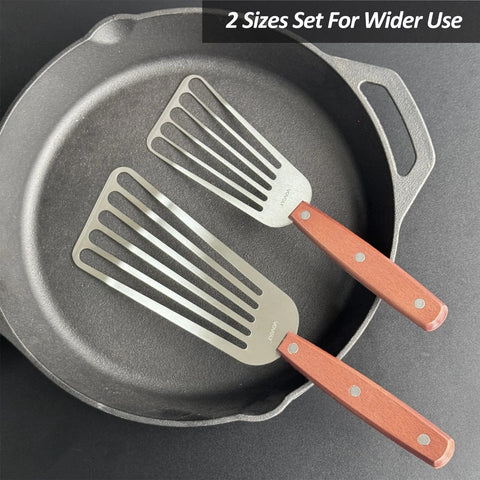 Overhead view of two-piece stainless steel slotted fish spatulas with wooden full-tang handles, sizes 3x6 in and 4x8 in.