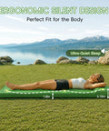 Person relaxing on Cloudlike Memory Foam Camping Sleeping Pad With Pillow, Foldable Self Inflating Mattress Pad outdoors by lake.