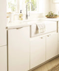 Aloft Satin Nickel Cabinet Edge Pull 4 And Nine Sixteenths Inch Center To Center Drawer Handle Aluminum Hardware installed in kitchen
