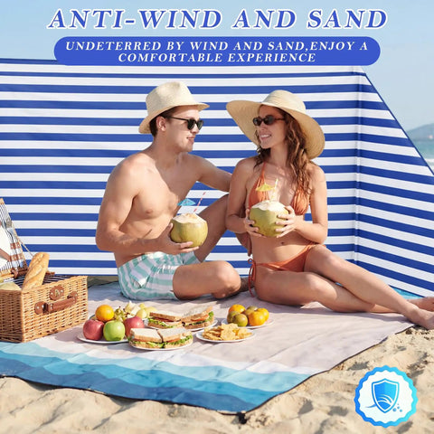 Couple relaxing in front of 15 By 5 Ft Beach Windscreen Set With Blue White Stripes, enjoying a picnic on the beach.