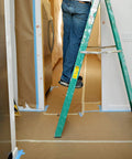 Person using ladder with Brown General Purpose Masking Paper 12 In X 180 Ft For Painting Trim Windows And Doors applied on floor