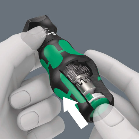 Hands holding Kraftform Kompakt Turbo 19-Piece Screwdriver Set with visible internal mechanical turbo boost and push button