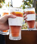Freezable Insulated Pint Mugs Set Of 2 Double Walled Frosty Drink Glasses With Gel Core Keeps Beer And Cold Brew Icy Longer 16 Oz, hands holding chilled drinks outdoors.