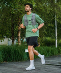 Man jogging wearing Ultra Lightweight Hydration Vest Backpack With 1.5L Insulated Water Bladder, Breathable Mesh Back, Gray