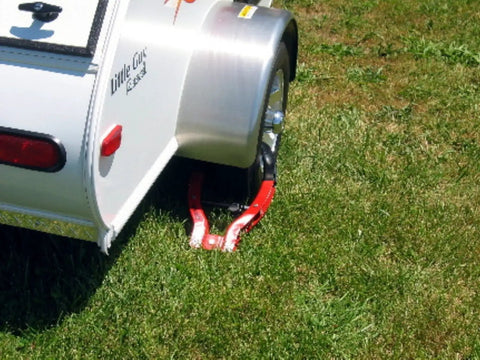 Tire Claw Security Device XL with Red and Black Finish Universal Fit installed on trailer wheel for theft deterrence