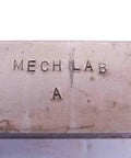 Close-up of engraved metal block labeled 'MECH LAB A', part of Four Piece Vintage Lathe Tool Holder Set Featuring Sick Precision Cutoff And Parting Turning Inserts Rock Solid Heavy Duty Carbon Steel Build For Dead Serious Metalworking Jobs And Smooth Shop Runs.