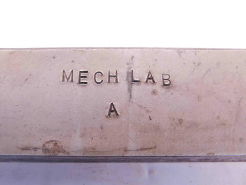 Close-up of engraved metal block labeled 'MECH LAB A', part of Four Piece Vintage Lathe Tool Holder Set Featuring Sick Precision Cutoff And Parting Turning Inserts Rock Solid Heavy Duty Carbon Steel Build For Dead Serious Metalworking Jobs And Smooth Shop Runs.