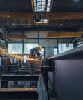 Worker using Beast Power 6 Inch 2000 Watt Brushless Angle Grinder For Industrial Use With Marathon Brushless Motor Efficient Dust Protection Quick DS BL WEPBA 20 150 Model Compact Yet Powerful Tool For Heavy Duty Cutting And Grinding in a factory