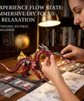 Person assembling Metal Dragon 3D Model Kit for Adults Boss Level Build, Mechanical Puzzle Craft, red finish on desk