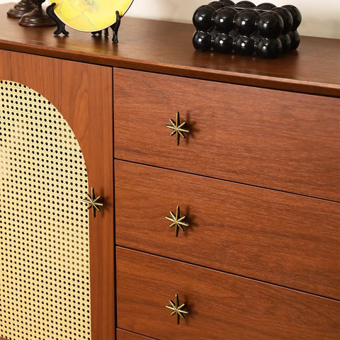 Close-up of dresser with Six Piece Antique Gold Cast Iron Drawer Pulls And Cabinet Knobs Set With Eight Pointed Star Burst Design