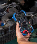 Person using Pro Grade Automotive Digital Multimeter with Auto Range and Overload Protection in engine diagnostics