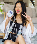 Smiling woman using Powerhouse Rechargeable Cordless Breast Pump With Hospital Strength Suction and Dual Adjustable Settings.