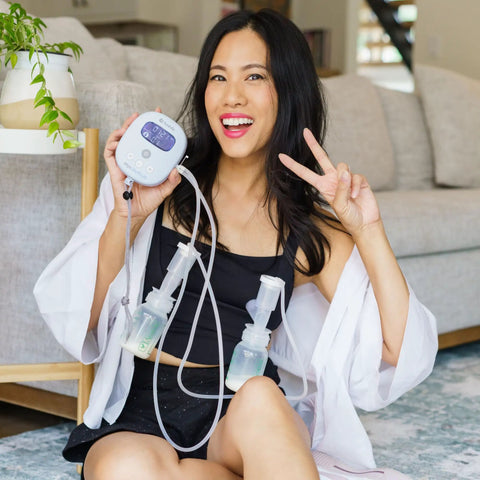 Smiling woman using Powerhouse Rechargeable Cordless Breast Pump With Hospital Strength Suction and Dual Adjustable Settings.