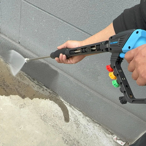 Person using Adjustable High Power Pressure Washer Gun With Swivel Length Options 37, 24, and 10 Inches for cleaning concrete wall.