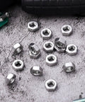 Top Shelf 50 Pc Stainless Steel Screw Nuts With Coarse Thread Heavy Duty Hex Fasteners Corrosion Proof Hardware on a textured surface.