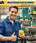 Front view of a worker in blue coveralls holding a yellow-lidded jar of industrial lubricating paste for drilling metal