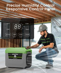 Industrial Grade 150 Pint Commercial Dehumidifier With Built In Pump And Drain Hose in use, displaying control panel and man adjusting settings.