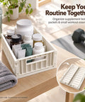 Top Shelf Foldable Storage Bins Four Pack Hella Space Savers For Tiny Apartments Dorm Rooms And Closets Easy Flat Fold Plastic Organizer Crates With Secure Lids Beige filled with supplements on a wooden table.