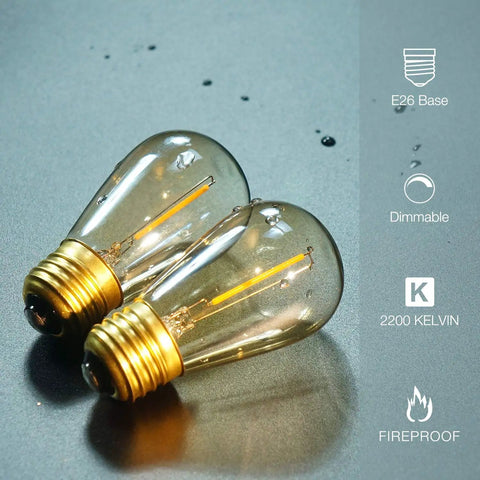 Close-up of 2 amber 2200K LED filament bulbs with E26 base, labeled dimmable and shatterproof, 25 Pack S14 String Light Bulbs Replacement