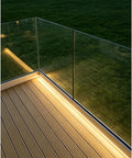 Adjustable Aluminum Glass Spigot Kit Built Tough For Decks And Pools installed on a patio with tempered glass panels and LED lighting.