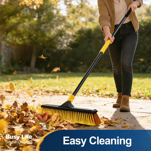 Person using 18 Inch Push Broom Heavy Duty Outdoor Commercial Broom With Stiff Bristles For Cleaning Patio in a garden