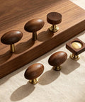 Kick Up Your Home Decor Game With Four Slick Bronze And Walnut Wood Cabinet Knobs Featuring Tight Vintage Style Brass Drawer Pulls For Kitchen And Dresser Cabinets: Set of five cabinet knobs with walnut wood and brass bases.