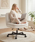 Woman sitting on Criss Cross Legged Swivel Office Chair With Wheels, Armless Wide Vanity Desk Chair In Scratch Resistant PU Leather, Beige